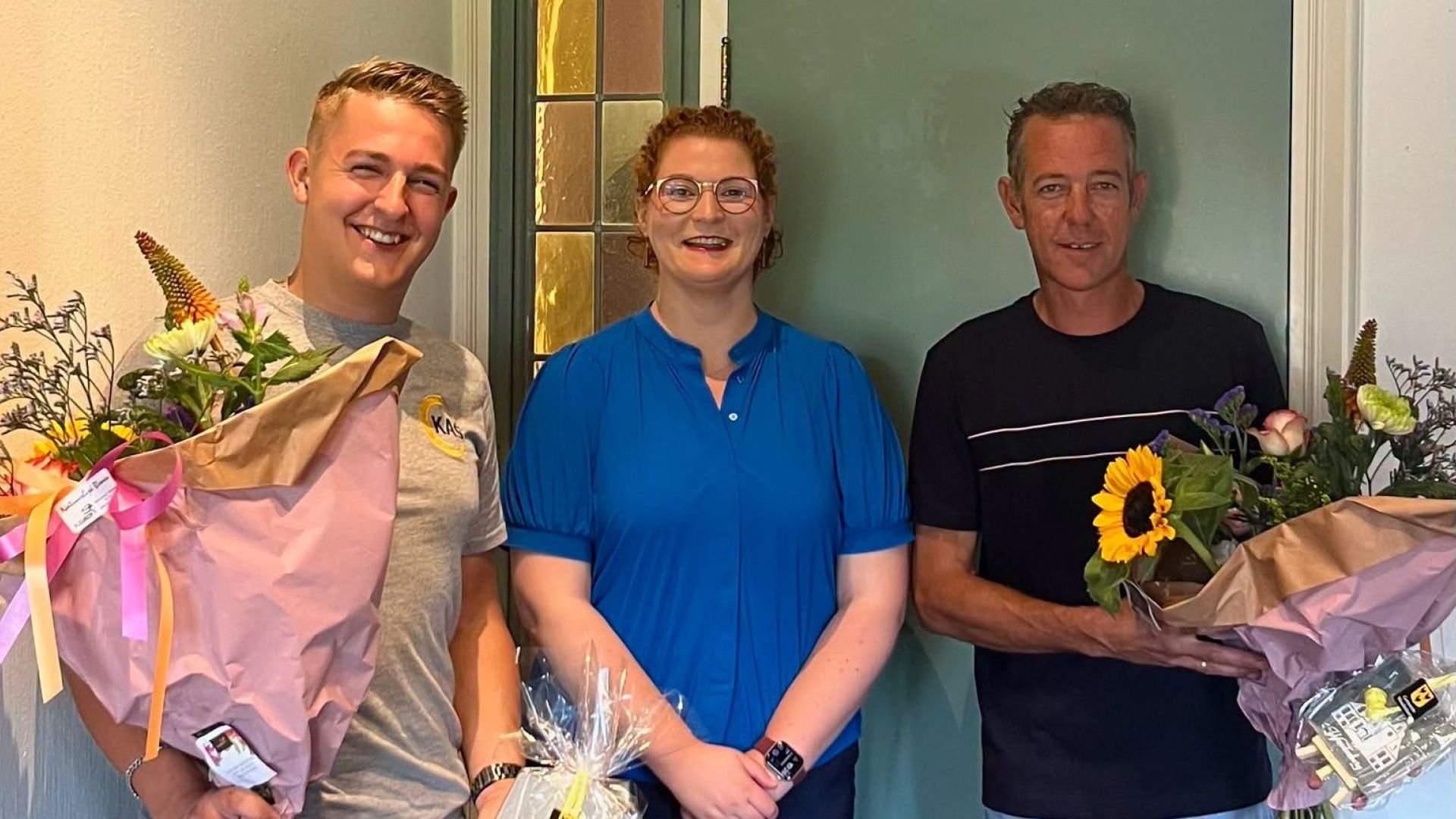 Samuel en Gerrit krijgen tegeltje en bloemen van gemeente Woudenberg voor inzet bij brand gemeentehu